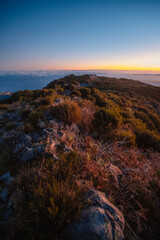 Hiking on the highest peak of Madeira Pico Ruivo next to the cottage Abrigo do Pico Ruivo. Views of...