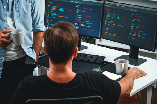 IT developers discussing online software development information on pc screen, creating program coding for latest version application on website. Concept of brainstorming firmware updated. Sellable.