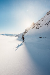 Mountaineer backcountry ski walking ski alpinist in the mountains. Ski touring in alpine landscape with snowy trees. Adventure winter sport. High tatras, Slovakia