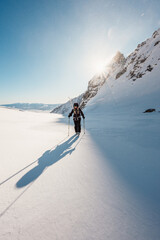 Mountaineer backcountry ski walking ski alpinist in the mountains. Ski touring in alpine landscape with snowy trees. Adventure winter sport. High tatras, Slovakia