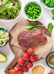Set of aw ingredients to cooking a healthy plate on on a marble background, beef tenderloin, bulgur...