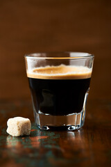 Coffee in glass cup on dark background. Close up. Copy space