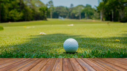 Wooden floor and golf course background. Fresh spring green golf course with wood floor. Beauty natural background, Empty wooden deck table with Green background.