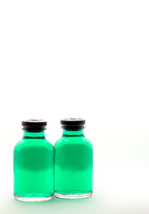 Medical medicine bottles with green liquid with syringe friendly plastic cap