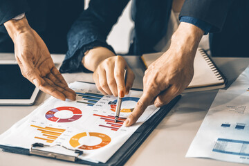 Businessman and businesswoman in meeting working with many financial statement document on desk....