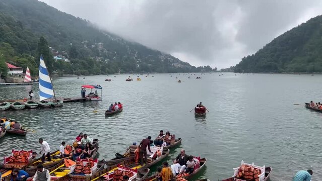 nainitaal, Uttarakhand, July 7, 2022 - wooden boats moving in the lake at cloudy