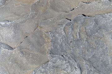 Stone texture worn by the wind and the sea of ​​the coast located on a wild beach.