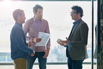 Business people, men and discussion with paperwork for partnership by window of office for b2b...