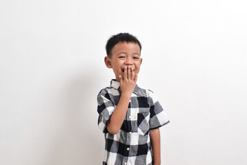 Image of Asian child posing covering his mouth with both hands on a white background. portrait of an Asian boy