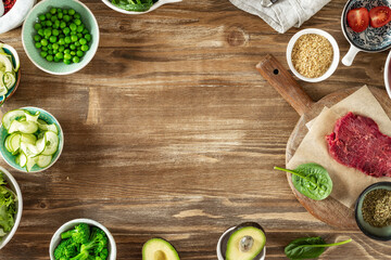 Set of raw ingredients to cooking a healthy plate on wooden table, beef tenderloin, bulgur grains...