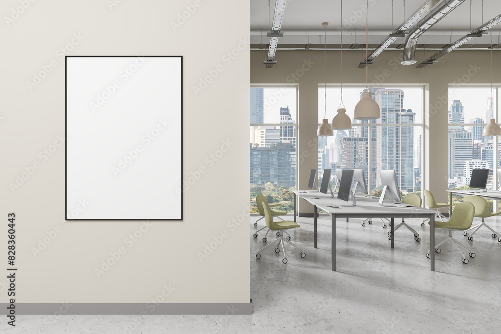 Aufkleber an office interior with a blank poster on a wall and computers on desks, light. concept of workspace