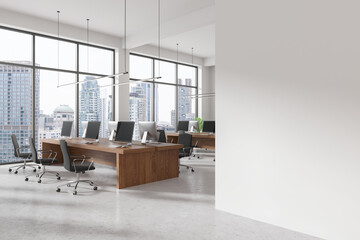 White workspace interior with pc computers on desks, window. Mockup wall