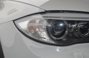 Fototapeta premium Car headlight close-up. Luxury vehicle detail of headlight.