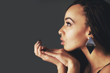 African woman, profile and earrings in studio with beauty, thinking and mock up space by dark...