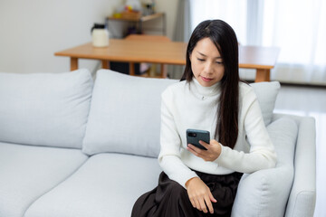 Woman use of mobile phone at home