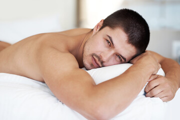 Morning, confident and portrait of man in bed to wake up from resting, relaxing and tired....