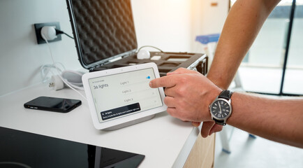 A technician works with a demo kit of the smart home system