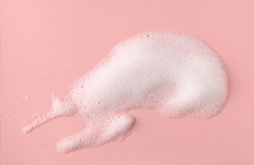 White skincare cleansing foam smudge on a pink background