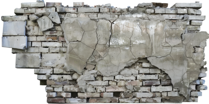 A collapsed and cracked concrete brick wall. The structure is in a state of ruin, with visible damage and deterioration.