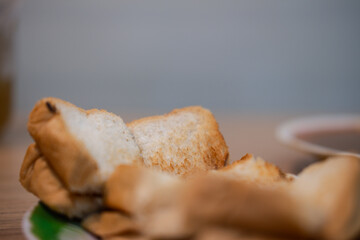 Grilled toasted bread cut into bite-sized pieces for side dish with pork satay sticks. Close up