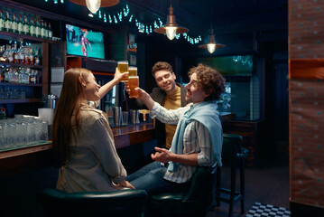 Friends employee celebrating while meeting to rest after work in bar