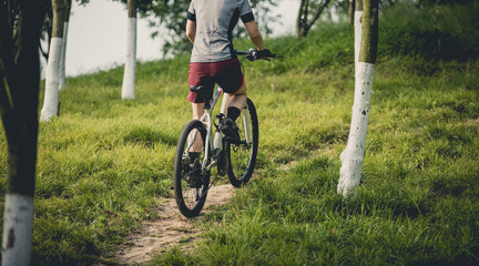 Woman mountain biking on mountain trail