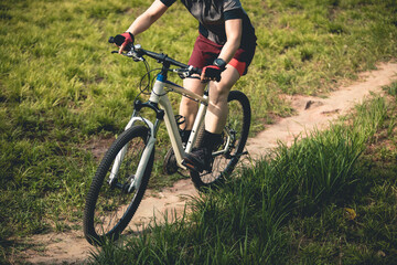Fototapeta premium Woman mountain biking on mountain trail