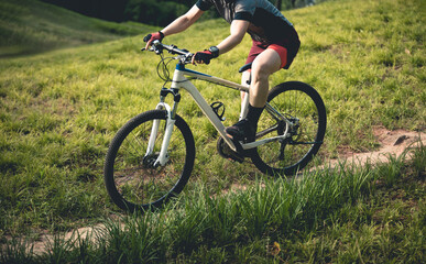 Fototapeta premium Woman mountain biking on mountain trail
