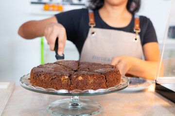 Moroccan woman serving a chocolate cake in a Moroccan cafe