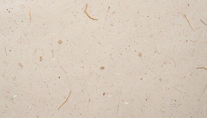 Close-up of beige paper texture with visible fibers and tiny specks, ideal for art and design projects.
