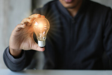 Men hand holding light bulb. idea concept with innovation and inspiration, Concept of inspiration...