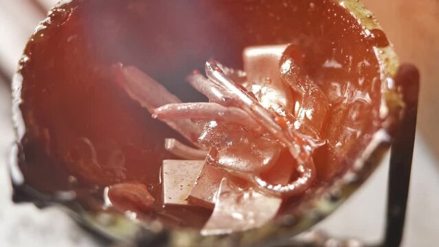 Heating with a flame jet of a metal billet of a silver ring. The work of a jeweler in the workshop