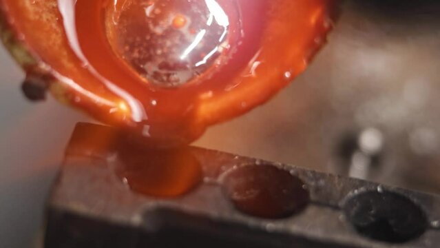 Heating with a flame jet of a metal billet of a silver ring. The work of a jeweler in the workshop