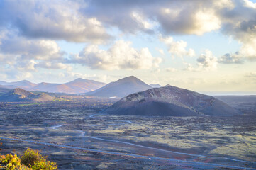 A stunning view of the volcanic landscape of El Cuervo vulcan at sunset, Lanzarote, Canary Island,...
