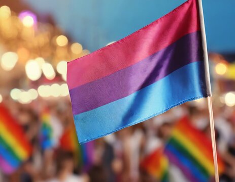 bisexual flag on the background of the pride parade, lgbt pride month, fight against homophobia, tolerance, rally of many people