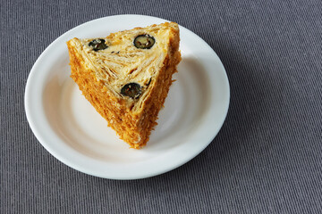 Chopped dough roll with whipped cream and blueberries on a plate
