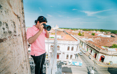 Tourist photographing the streets of Granada from the La Merced viewpoint. Tourist man taking photos of the roof of the colonial houses in Granada
