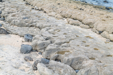 Basalt. Beachrock is a friable to well-cemented sedimentary rock that consists of a variable mixture of gravel , sand , and silt-sized sediment. fragments of coral and shells . Geology