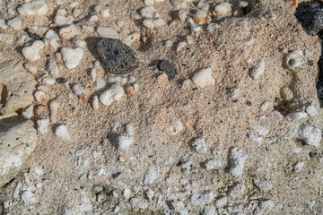 Beachrock is a friable to well-cemented sedimentary rock that consists of a variable mixture of basalt gravel , sand , and silt-sized sediment. fragments of coral and shells . Geology 

