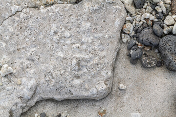 Beachrock is a friable to well-cemented sedimentary rock that consists of a variable mixture of basalt gravel , sand , and silt-sized sediment. fragments of coral and shells . Geology 

