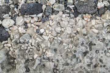 Beachrock is a friable to well-cemented sedimentary rock that consists of a variable mixture of basalt gravel , sand , and silt-sized sediment. fragments of coral and shells . Geology 
