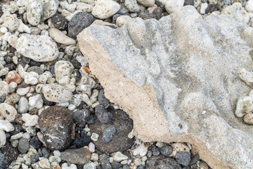 Beachrock is a friable to well-cemented sedimentary rock that consists of a variable mixture of basalt gravel , sand , and silt-sized sediment. fragments of coral and shells . Geology 
