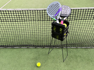 Background of padel racket and ball on artificial grass floor in outdoor court. Top view.