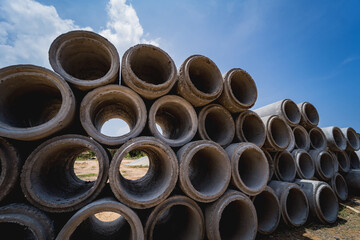 A stack of concrete ring pipes piled and creating a symmetrical arrangement