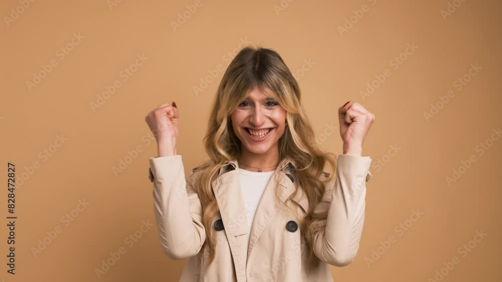 Wall mural Enthusiastic transgender woman with clenched fists celebrating victory