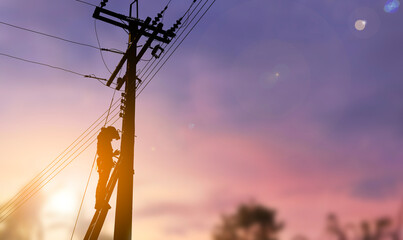 A technician work on high electricity pole silhouette style