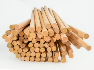 stack of hardwood dowel rods pins for crafting and woodworking