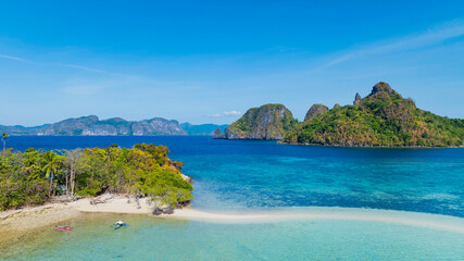 Aerail view of  tropical exotic island sand bar separating sea in two with turquoise  in El Nido,...