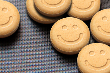 MDMA or Ecstasy pills on fabric background