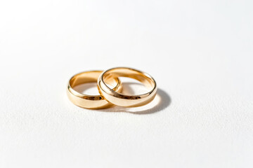 Two Gold Wedding Bands on White Background